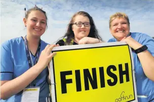  ??  ?? Finish line Organisers Rachel Cox ( right), her daughter Becky ( left) and Sarah Marshall