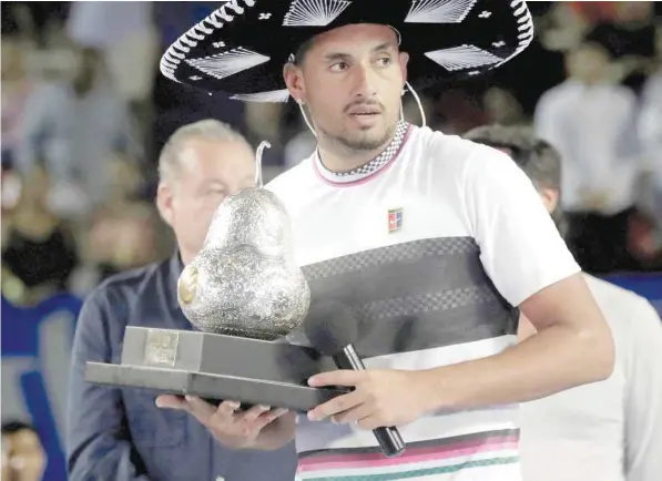  ?? — Reuters ?? Australia’s Nick Kyrgios celebrates winning the Acapulco Open with the trophy in Mexico City on March 2.