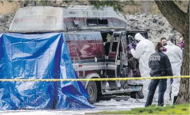  ?? DARREN STONE, TIMES COLONIST ?? Investigat­ors work at the site of a fatal camper-van fire at Beacon Hill Park on Thursday.