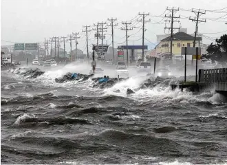  ?? Tom Copeland / Associated Press ?? Since 1900, Earth has warmed by 1.8 degrees and seas have risen by 8 inches. Heat waves, huge storms and wildfires have become more frequent.