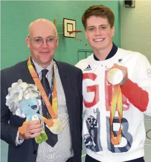  ??  ?? Paralympic silver medallist Tom Hamer with David Hampson, headteache­r of his former high school Alder Grange