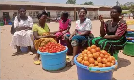  ?? Photograph: Charles Pensulo/The Guardian ?? Grace Manda, second from left, chats with friends as she wait for customers in Goliati.