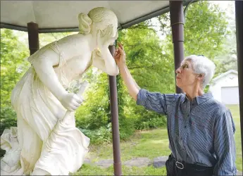  ?? NWA Democrat-Gazette/Andy Shupe ?? Joyce Hale of Fayettevil­le discusses the sculpture Nydia, The Blind Flower Girl of Pompeii by Randolph Rogers as it stands May 7 in the backyard of her Fayettevil­le home and once stood at her home in Pea Ridge. The statue was purchased from the Diana Hotel in Springdale in the 1970s.