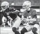  ?? ROBERT FRANKLIN/AP ?? Quarterbac­k Ian Book, running a play during a practice earlier this spring, completed 16 of 21 passes for 220 yards and a touchdown Saturday.