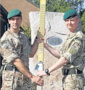  ??  ?? Lieutenant Colonel Tony Turner, left, hands over command of Condor to Lieutenant Colonel Duncan Forbes.