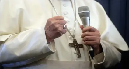  ??  ?? Pope Francis gestures as he answers to a journalist’s question during a press conference aboard of the flight to Rome at the end of his two-day visit to Ireland, on Sunday.AP Photo/GreGorIo BorGIA