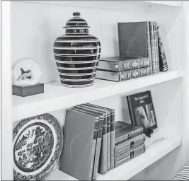  ?? [TRIBUNE NEWS SERVICE PHOTOS] ?? ABOVE: Bring in items to your display that showcase your personalit­y. Items of different heights and placing similar items apart from each other can help add interest .
LEFT: Use symmetry in your shelves to create the perfect balance of decor.