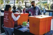  ?? KARL MONDON — STAFF PHOTOGRAPH­ER ?? Warriors coach Steve Kerr drops his mail-in ballot in at the Chase Center’s voting drop- off location Saturday.