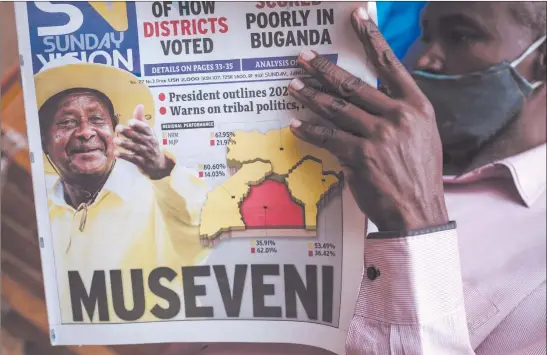  ?? Nampa/AFP ?? Ugandans decided… A man reads the Sunday Vision newspaper whose front page shows a portrait of re-elected President Yoweri Museveni on Sunday at a kiosk on a street in Kampala, a day after the election commission said he won a sixth term in office.