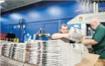  ?? ANGELA MAJOR/THE JANESVILLE GAZETTE VIA AP ?? Production workers stack newspapers at the Gazette printing plant in Janesville, Wis.