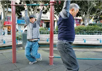  ??  ?? Right: Sze Po (left) of San Francisco, exercising on equipment in Portsmouth Square in Chinatown, mourned the death of the mayor.