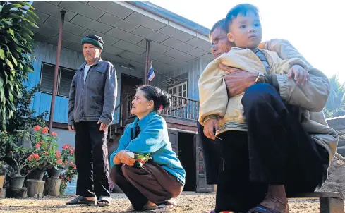  ?? TAWATCHAI KHEMGUMNER­D ?? Villagers at Ban Pang Lao in Chiang Rai’s Muang district — from left Thongluan Nonthapha, Pramuan Nonthapha, and Thirayuth Onsri — wait for news from their sons who work in South Korea. The village was once plagued with drug addiction among youths....