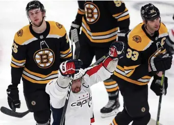  ?? MATT STONE / BOSTON HERALD ?? FAMILIAR FEELING: Bruins defensemen Brandon Carlo (25) and Zdeno Chara react as the Capitals’ Alex Ovechkin celebrates the first of his two goals in the Bruins’ 4-2 loss last night at the Garden.