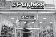  ?? [BLOOMBERG PHOTO BY SCOTT EELLS] ?? A pedestrian passes in front of a Payless ShoeSource store in New York.
