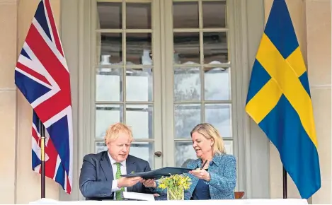  ?? ?? Prime Minister Boris Johnson signs security agreements with Swedish prime minister Magdalena Andersson.