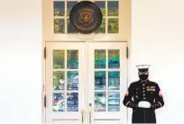  ?? CHIP SOMODEVILL­A GETTY IMAGES ?? A U.S. Marine stands guard outside the West Wing at the White House as President Donald Trump works inside.