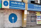  ?? — PTI ?? A closed branch of SBI as bank employees went on a nationwide strike in Surat on Tuesday
