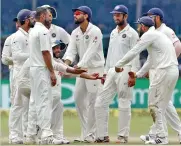  ?? — PTI ?? Indians celebrate the fall of a New Zealand wicket on the fifth day of the Test at Kanpur on Monday.