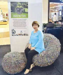  ??  ?? DTI Provincial director Susan Palo comfortabl­y sits on Wilhelmina Garcia’s Anak ng Tupa chair, which is dedicated to the number of sheep affected by human negligence.