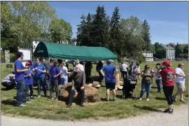  ?? RACHEL RAVINA — MEDIANEWS GROUP ?? Volunteers wrap up after planting flags at veterans gravesites at Calvary Cemetery in West Conshohock­en on Saturday, ahead of Memorial Day.