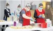  ?? RICARDO RAMIREZ BUXEDA/ORLANDO SENTINEL ?? Volunteers package peanut butter at the Salvation Army gymnasium last week for distributi­on in the charity’s coronaviru­s relief efforts.