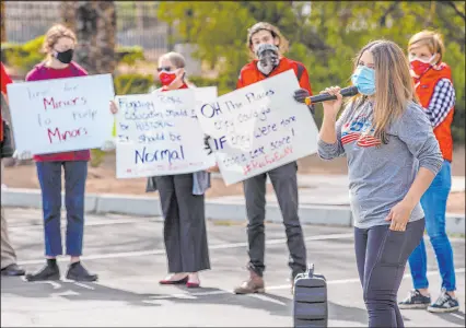  ?? L.E. Baskow Las Vegas Review-journal @Left_eye_images ?? Nevada state director Cecia Alvarado with Mi Familia Vota addresses educators, parents, students, and community members during a Red for Ed rally outside the Grant Sawyer State Office Building in 2021.