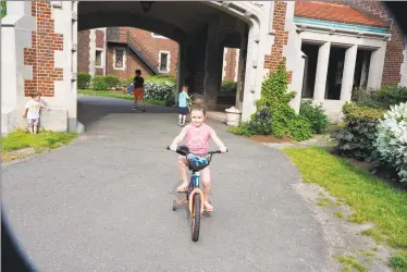  ?? Grace Duffield / Hearst Connecticu­t Media ?? Nadiya Pivtorak, 6 years old, was riding her friend’s bike in front of the Waveny House in New Canaan on May 27. Business is not as good as it might be for bicycle stores, because there are problems with bicycle distributi­on, since most bikes come from Asia.