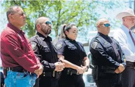  ?? CHRISTOPHE­R LEE/THE NEW YORK TIMES ?? Pete Arredondo, the school district police chief in Uvalde, Texas, second from right, stands during a news conference last month in the town.