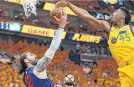  ?? [AP PHOTO] ?? Jazz guard Donovan Mitchell defends against Thunder center Steven Adams during the first half of Game 6 Friday in Salt Lake City.