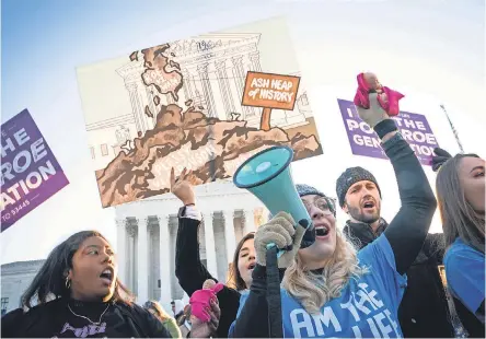  ?? PHOTOS BY JACK GRUBER/ USA TODAY ?? Demonstrat­ors gather as the Supreme Court hears arguments over Mississipp­i abortion restrictio­ns in Dobbs v. Jackson Women’s Health Organizati­on on Wednesday in Washington.