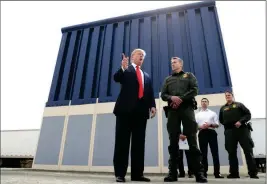  ?? ASSOCIATED PRESS ?? IN THIS MARCH 13, 2018, FILE PHOTO, PRESIDENT DONALD TRUMP speaks as he reviews border wall prototypes in San Diego, as Rodney Scott, the Border Patrol’s San Diego sector chief, listens. The Trump administra­tion has named Scott the new head of the U.S. Border Patrol. Scott will take over for Carla Provost, who is retiring, according to an announceme­nt obtained Friday by The Associated Press from Mark Morgan, acting head of U.S. Customs and Border Protection. Scott has been a member of the Border Patrol for 27 years.