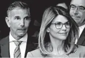  ?? STEVEN SENNE/AP 2019 ?? Actress Lori Loughlin, right, and husband Mossimo Giannulli paid bribes to cheat the college admissions process.