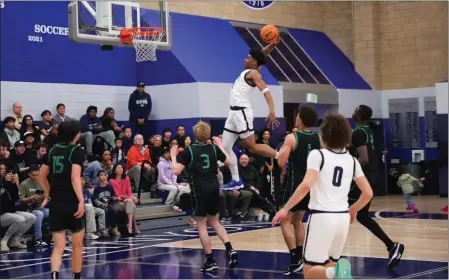  ?? COURTESY OF GREG STEIN ?? Sierra Canyon's Isaiah Elohim flies toward the rim for a dunk in Wednesday's loss to St. Joseph in the first round of the Open Division regional playoffs.