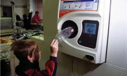  ??  ?? A young boy recycles plastic bottles in an automatic bottle bank inside a supermarke­t, Leichlinge­n, Germany. Photograph: Clynt Garnham/Alamy