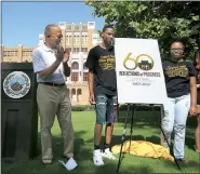  ?? Arkansas Democrat-Gazette/STATON BREIDENTHA­L ?? City Manager Bruce Moore (from left) applauds Wednesday as Little Rock Central High School students Tarvoais Carroll, 18, and Breyona Butler, 17, unveil the logo for this year’s commemorat­ion of the 60th anniversar­y of the integratio­n of the school.