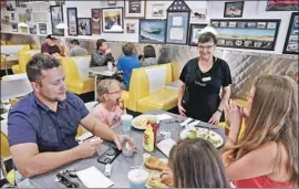  ?? GARY CORONADO Los Angeles Times ?? A FAMILY eats at a Yuba City, Calif., diner in May. Yuba and Sutter counties, which defied state shutdown orders at the time, are now on the state’s watchlist.