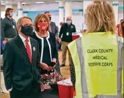  ?? BILL LACKEY / STAFF ?? Gov. Mike DeWine and his wife, Fran, talk with volunteers as they visit the Clark County vaccine distributi­on center Thursday.