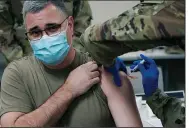  ?? (AP/Rogelio V. Solis) ?? Brig. Gen. Clint Walker of the Mississipp­i National Guard gets the first round of the Moderna vaccine Wednesday in Flowood, Miss. Officials have administer­ed 200 doses to Guard members who serve as first responders or work at coronaviru­s testing sites.