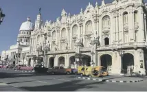  ??  ?? Cars from the 1950s can still be seen on the streets of Havana, the legacy of the US blockade of the country imposed in 1961, main; the Gran Teatro Alicia Alonso, above