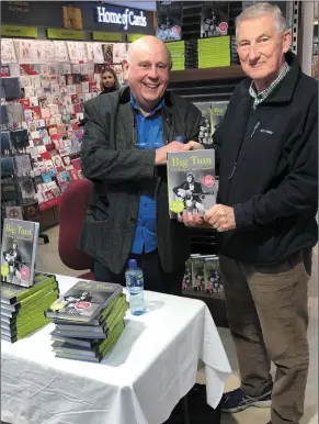  ??  ?? Book signing: Vincent Nally gets his copy of the book Big Tom - The King of Irish Country signed by author Tom Gilmore at Eason’s Sligo during its successful launch recently in Eason’s Sligo.