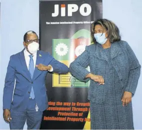  ??  ?? Minister of state in the Ministry of Industry, Investment and Commerce Dr Norman Dunn greets executive director of the Jamaica Intellectu­al Property Office, Lilyclaire Bellamy in typical COVID-19 fashion at JIPO’S office last week.