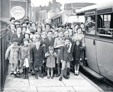  ??  ?? Children of the Mount Zion Methodist Sunday School pose to have their picture taken by the coaches that will take them on their summer outing, July 14 1936. They’re probably heading for Weston or Burnham-onSea. We thought we’d show you this one as the big crack down it illustrate­s how fragile these glass negatives were – and how lucky we are that they’ve survived at all!