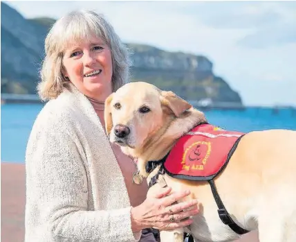  ??  ?? > Burnadette Clutton with her Labrador assistance dog Maisy