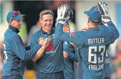  ??  ?? HIGH FIVE: England’s Chris Woakes, second left, celebrates after taking his fifth wicket against Pakistan at Headingley