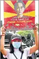  ?? REUTERS ?? A demonstrat­or holds up a placard with the image of Aung San Suu Kyi in Yangon, Myanmar, on Monday.