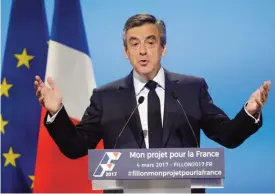  ?? — AFP ?? AUBERVILLI­ERS: French presidenti­al election candidate for the right-wing Les Republicai­ns (LR) party Francois Fillon delivers a speech to present his program during a campaign meeting in Aubervilli­ers, outside Paris yesterday.