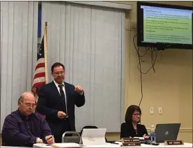  ?? THE NEWS-HERALD FILE ?? Fairport Harbor Schools Superinten­dent Domenic Paolo, standing, makes a point during his State of the Schools speech in February of 2019. He’s flanked by Fairport Harbor Village Fiscal Officer Chris Paquette, left, and Administra­tor Amy Cossick.