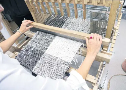  ?? THE NEW YORK TIMES ?? Tweed fabric is made from plastics, paper and other materials at Lesage, the embellishm­ent specialty company that is one of Chanel’s métiers d’art houses.