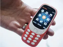  ?? — AFP ?? BARCELONA: A person holds the new “Nokia 3310” model of Finnish company HMD Global on the first day of the Mobile World Congress yesterday. (See Page 27)