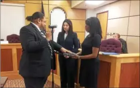  ?? EVAN BRANDT — DIGITAL FIRST MEDIA ?? Seventh Ward Councilman Joseph Kirkland, left, was accompanie­d by his wife Eucharis Tuesday night for his oath taking. He later expressed disappoint­ment that action on reopening the budget did not begin immediatel­y.